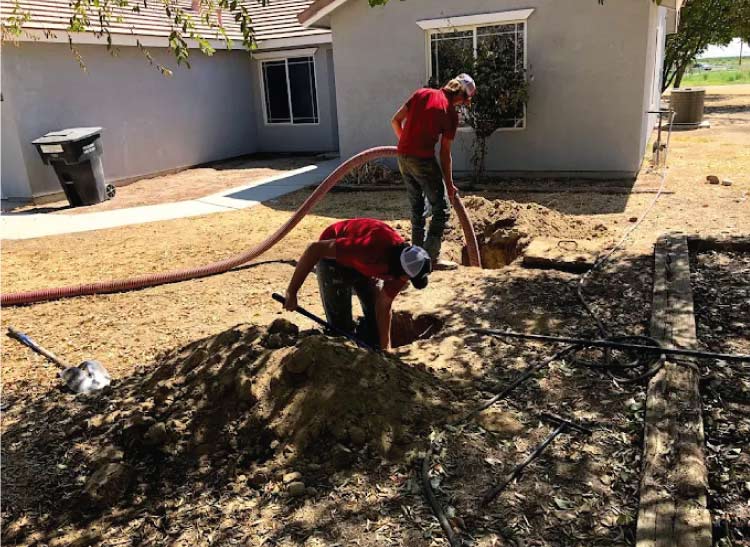 Licensed plumber performing septic tank pumping in a residential house in bakersfield ca
