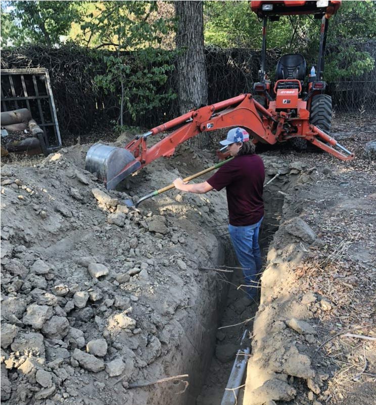 A professional plumber performing a commercial plumbing repair in bakersfield ca