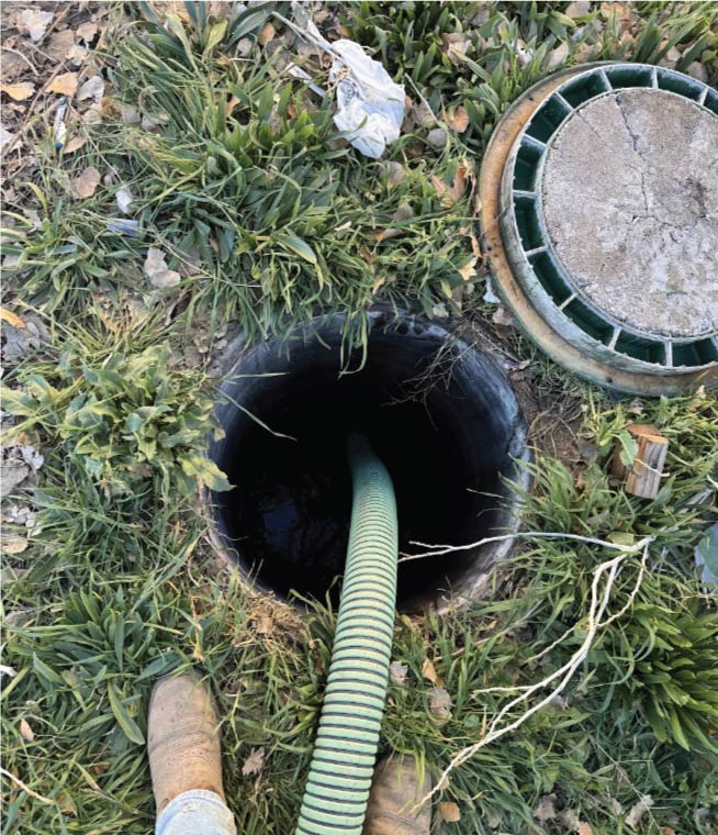 Licensed plumber performing a septic tank certification inspection in Bakersfield, CA.