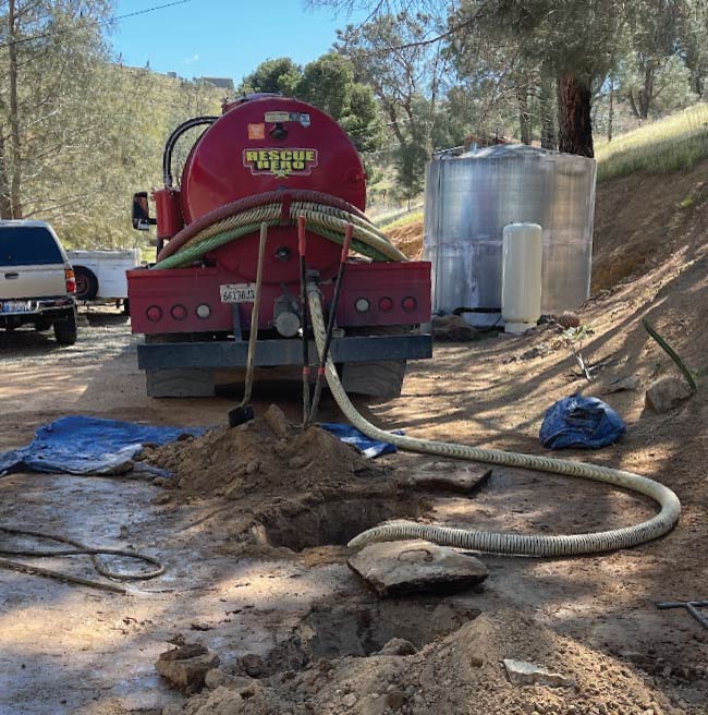 Licensed plumber performing septic tank pumping in a residential house in bakersfield ca