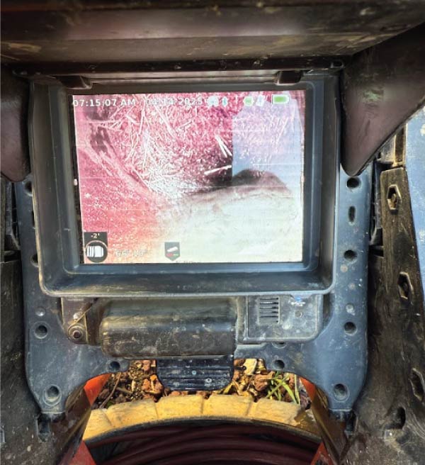Plumber using a sophisticated electronic tool to pinpoint the source of a hidden water leak