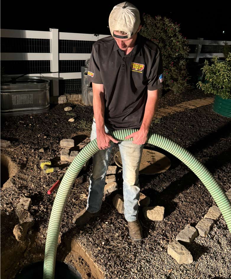 A certified plumber technician performing septic tank cleaning
