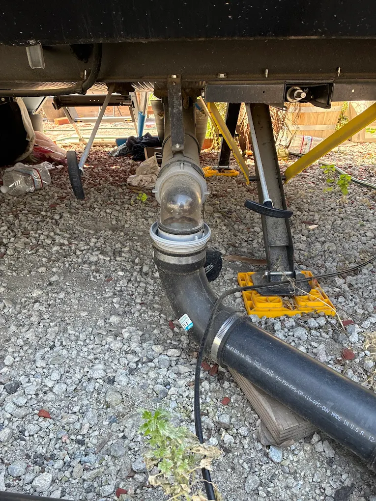 Close-up of flexible corrugated drainage piping and structural conduits used in commercial wastewater management.